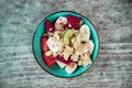 Healthy bowl with oat, sliced fruits: banana, dragon fruit, lime, papaya. Food photo from above. Royalty Free Stock Photo