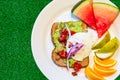 Breakfast for a healthy lifestyle. Avocado toast, poached egg and sliced fruit