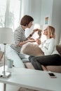 Two beautiful ladies sitting on the couch at their apartments Royalty Free Stock Photo