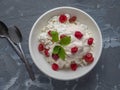 Breakfast from homemade cottage cheese with sour cream of melted cream with berries dried cherries in a deep white plate, on a