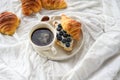 Breakfast: hot coffee and blueberry croissant