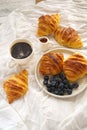 Breakfast: hot coffee and blueberry croissant