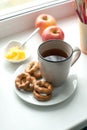 Breakfast with hot tea, cookies and honey. Healthy home breakfast cincept. Close up of a cup of tea with cookies on white dish Royalty Free Stock Photo