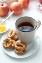 Breakfast with hot tea, cookies and honey. Healthy home breakfast cincept. Close up of a cup of tea with cookies on white dish Royalty Free Stock Photo