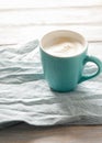 Breakfast idea. Cup with coffee on linen napkin and wooden background