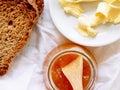 Breakfast with integral toast, butter and apricot jam on wooden table Royalty Free Stock Photo
