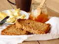 Breakfast with integral toast, butter and apricot jam on wooden table Royalty Free Stock Photo