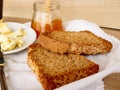 Breakfast with integral toast, butter and apricot jam on wooden table Royalty Free Stock Photo