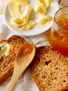 Breakfast with integral toast, butter and apricot jam on wooden table Royalty Free Stock Photo