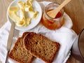 Breakfast with integral toast, butter and apricot jam on wooden table Royalty Free Stock Photo