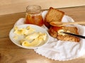 Breakfast with integral toast, butter and apricot jam on wooden table Royalty Free Stock Photo