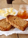 Breakfast with integral toast, butter and apricot jam on wooden table Royalty Free Stock Photo