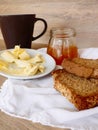 Breakfast with integral toast, butter and apricot jam on wooden table Royalty Free Stock Photo