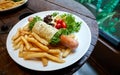 Jumbo sausage wrap with egg, fries, tomato and vegetable Royalty Free Stock Photo