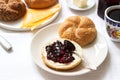 Breakfast with Kaiser rolls, currant jam, butter and cheese and tea