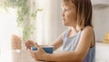 Breakfast in the Kitchen: Portrait of Adorable Little Girl Eating Healthy Granola Cereal with Milk Royalty Free Stock Photo