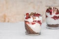 Breakfast layered parfait dessert with yogurt, sponge biscuit and fresh strawberry, white background copy space/ Royalty Free Stock Photo