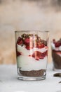 Breakfast layered parfait dessert with yogurt, sponge biscuit and fresh strawberry, white background copy space Royalty Free Stock Photo