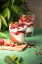Breakfast layered parfait dessert with yogurt, sponge biscuit and fresh strawberry, white background copy space Royalty Free Stock Photo