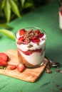 Breakfast layered parfait dessert with yogurt, sponge biscuit and fresh strawberry, white background copy space Royalty Free Stock Photo