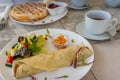 Breakfast, light meal table setting with crepe wrap, salad and belgian waffles Royalty Free Stock Photo