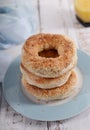 Sesame bagel stack on white wood