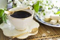 Breakfast with morning coffee cup and white cherry flowers on blossom branch. Concept nostalgia, memories, tenderness