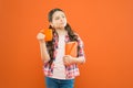 Breakfast the most important meal of the day. Little child having breakfast on orange background. Cute pupil holding