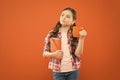 Breakfast the most important meal of the day. Little child having breakfast on orange background. Cute pupil holding