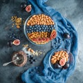 Breakfast with muesli, berries and nuts on dark background. Flat lay, Top view