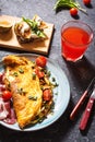 Breakfast mushrooms omelet and sandwich with figs on stone background