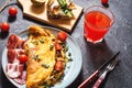 Breakfast mushrooms omelet and sandwich with figs on stone background.