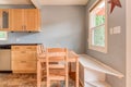 Breakfast nook wooden bright kitchen light blue walls wood tile floor