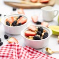 Breakfast oatmeal porridge with fresh fruits and berries, chia seeds on white marble background. Oatmeal with strawberry Royalty Free Stock Photo