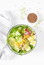 Breakfast oatmeal porridge with fresh vegetable salad of cucumber, radish, lettuce, corn, avocado, chia seeds and boiled eggs Royalty Free Stock Photo