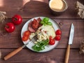 Breakfast of omelet with fried sausage and fresh tomatoes, and arugula and basil, coffee with milk in a ceramic mug Royalty Free Stock Photo