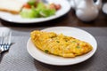 Breakfast omelette, scrambled eggs on Table