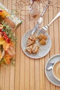 Breakfast outside - eating doughnut among autumn decorations. Cappuccino in white ceramic cup on wooden table. Aesthetic Royalty Free Stock Photo