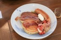 Breakfast pancakes bacon and sausages on wooden table. Homemade Continental breakfast at home kitchen, Royalty Free Stock Photo