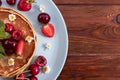 Breakfast. Pancakes with berries on a wooden background. ÃÂ¡opy space, top view