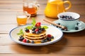 breakfast pancakes with maple syrup and fresh berries on ceramic plate Royalty Free Stock Photo