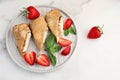 Breakfast with Pancakes with sauce, strawberries. White background