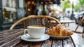 Breakfast in a Parisian street cafe - cup of coffee, croissant.