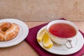 Breakfast with pastries, and hot tea with lemon. Royalty Free Stock Photo