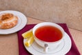 Breakfast with pastries, and hot tea with lemon. Royalty Free Stock Photo