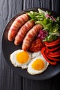 Breakfast Pigs in blankets fried sausages wrapped in bacon, eggs Royalty Free Stock Photo