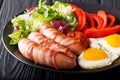 Breakfast Pigs in blankets fried sausages wrapped in bacon, eggs Royalty Free Stock Photo