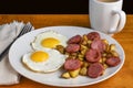breakfast plate of fried eggs , home frie and kielbasa