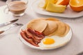 Breakfast plate with pancakes, eggs, bacon and fruit. Royalty Free Stock Photo