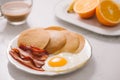Breakfast plate with pancakes, eggs, bacon and fruit. Royalty Free Stock Photo